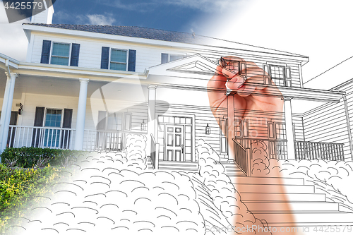 Image of Male Hand Sketching with Pencil the Outline of a House with Phot