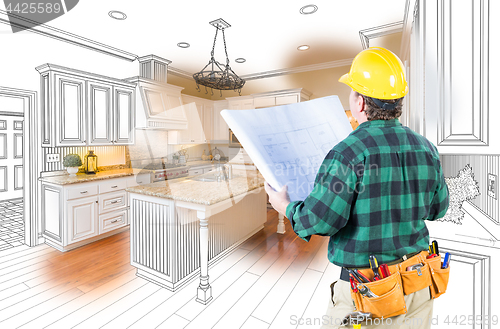 Image of Male Contractor with Hard Hat and Plans Looking At Custom Kitche