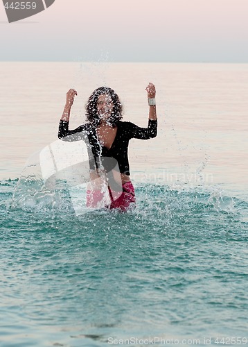 Image of woman in wet clothes splashing