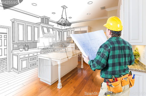 Image of Male Contractor with Hard Hat and Plans Looking At Custom Kitche