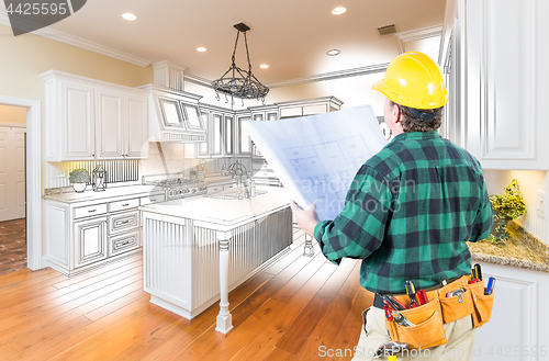 Image of Male Contractor with Hard Hat and Plans Looking At Custom Kitche