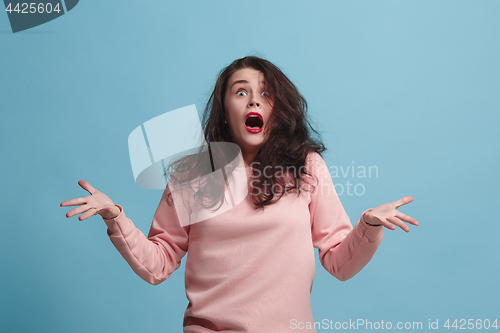 Image of The squint eyed woman with weird expression isolated on blue