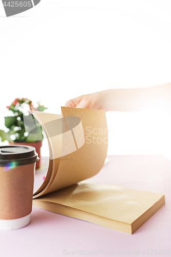 Image of The business woman in the workplace flips through the dailybook