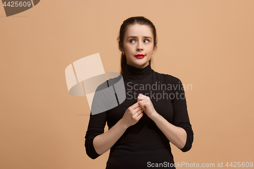 Image of Let me think. Doubtful pensive woman with thoughtful expression making choice against pastel background