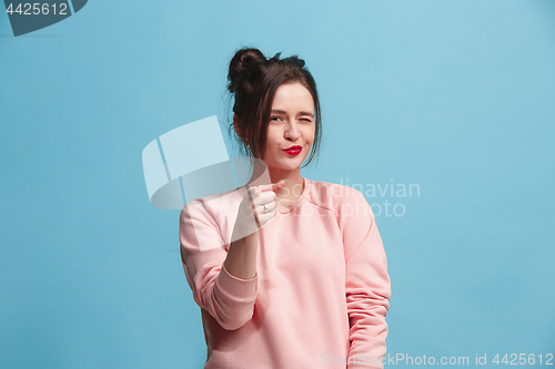 Image of The happy business woman point you and want you, half length closeup portrait on blue background.