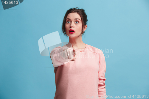 Image of The overbearing business woman point you and want you, half length closeup portrait on blue background.