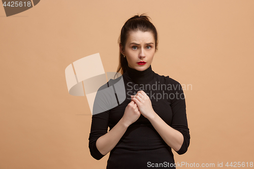 Image of Let me think. Doubtful pensive woman with thoughtful expression making choice against pastel background