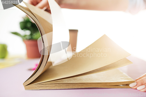 Image of The business woman in the workplace flips through the dailybook