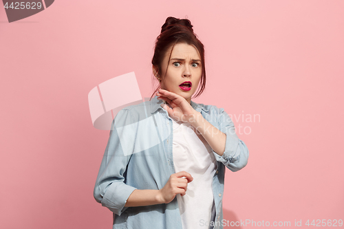 Image of Portrait of the scared woman on pink