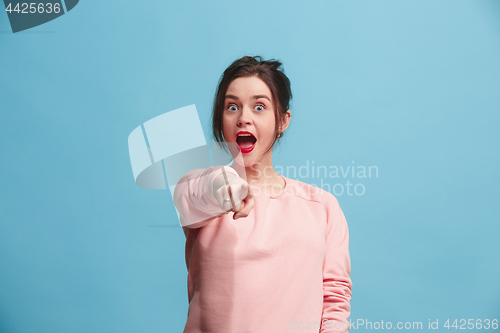 Image of The happy business woman point you and want you, half length closeup portrait on blue background.