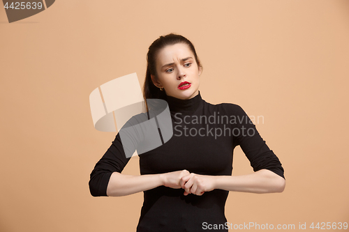 Image of Let me think. Doubtful pensive woman with thoughtful expression making choice against pastel background