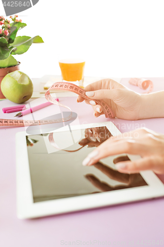 Image of Woman and fruit diet while working on computer in office