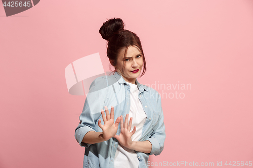 Image of Let me think. Doubtful pensive woman with thoughtful expression making choice against pink background