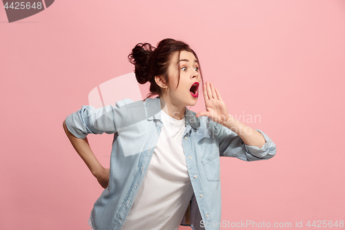 Image of Isolated on pink young casual woman shouting at studio