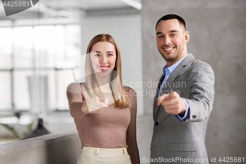 Image of businesswoman and businessman pointing at you