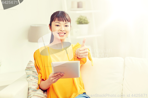 Image of happy asian woman with tablet pc and thumbs up