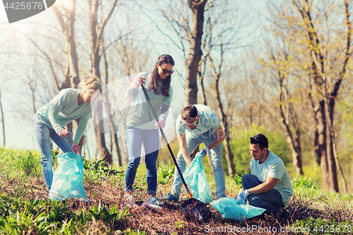 Image of volunteers with garbage bags cleaning park area