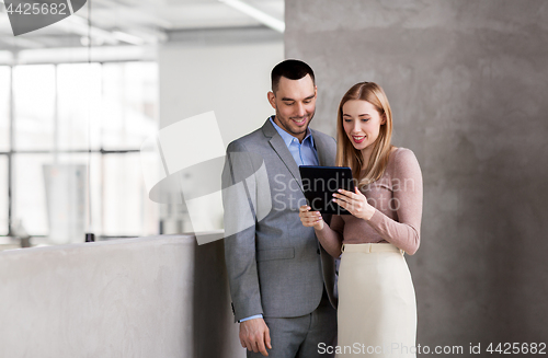 Image of businesswoman and businessman with tablet pc