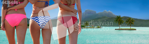 Image of close up of young women hugging on beach from back