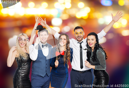 Image of happy friends with party props posing