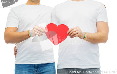 Image of couple with gay pride rainbow wristbands and heart