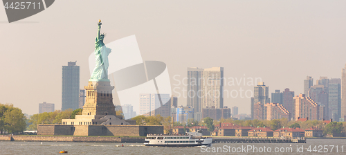 Image of Statue of Liberty with Liberty State Park and Jersey City skyscrapers in background, USA