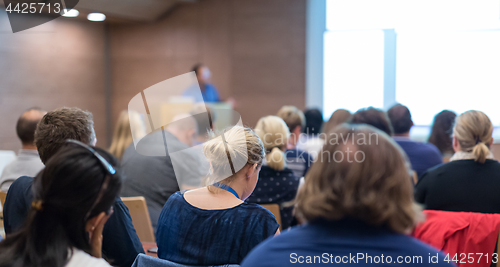 Image of Speaker giving presentation on health care conference.