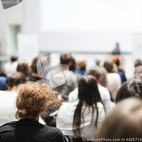 Image of Woman giving presentation in lecture hall at university.