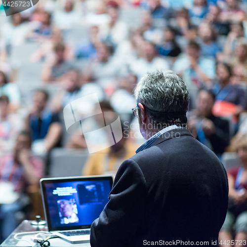 Image of Public speaker giving talk at Business Event.