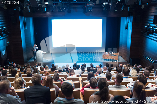 Image of Speaker giving presentation on health care conference.