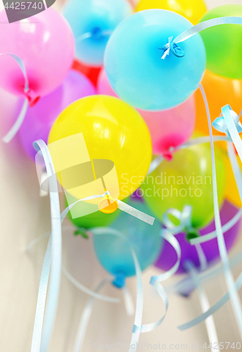 Image of Bunch of floating colored balloons and strings 