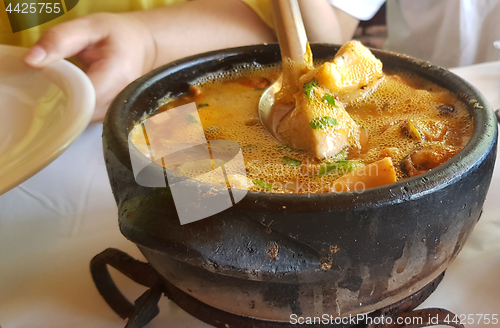 Image of clay pan with seafood 
