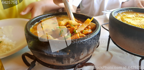 Image of clay pan with seafood 
