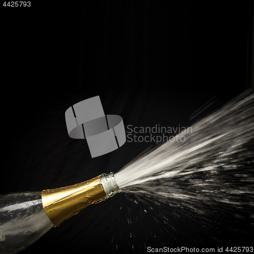 Image of champagne splashing out of the bottle