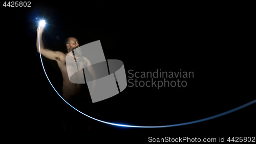 Image of man sending a flash light in the dark