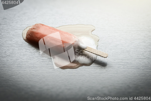 Image of A strawberry popsicle is melting