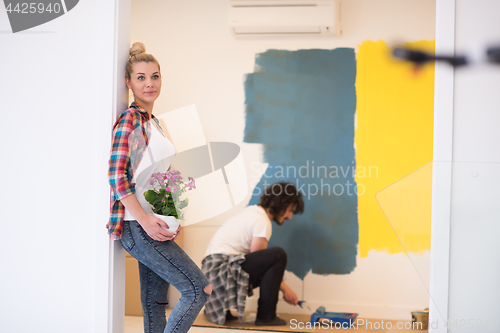 Image of happy young couple doing home renovations