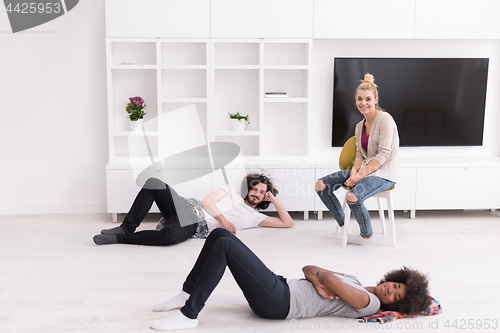 Image of multiethnic group of people relax in their new apartment