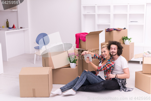 Image of young couple moving  in new house