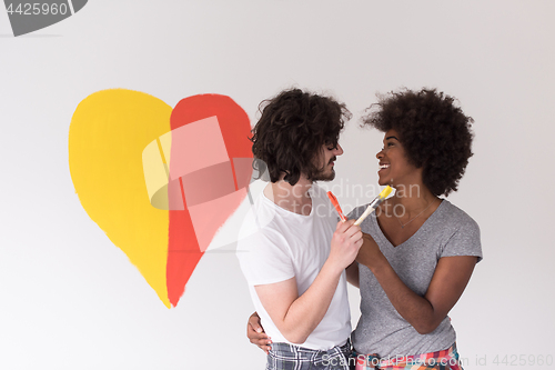 Image of couple with painted heart on wall