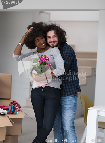 Image of multiethnic couple moving into a new home