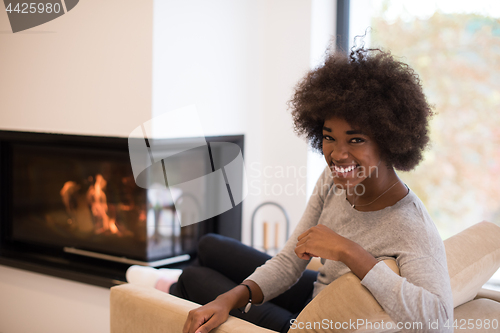 Image of black woman in front of fireplace