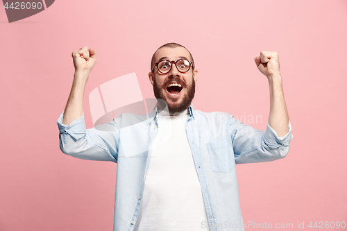 Image of Winning success man happy ecstatic celebrating being a winner. Dynamic energetic image of male model