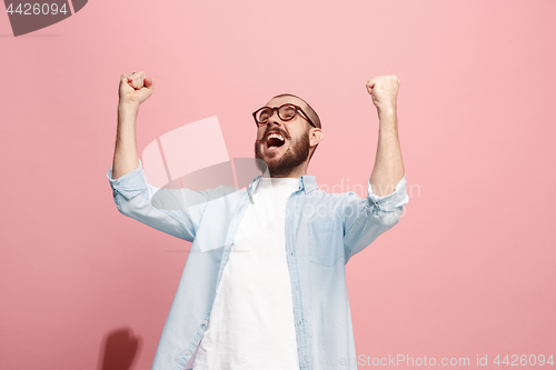 Image of Winning success man happy ecstatic celebrating being a winner. Dynamic energetic image of male model