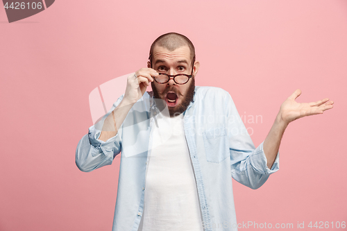 Image of Beautiful man looking suprised isolated on pink