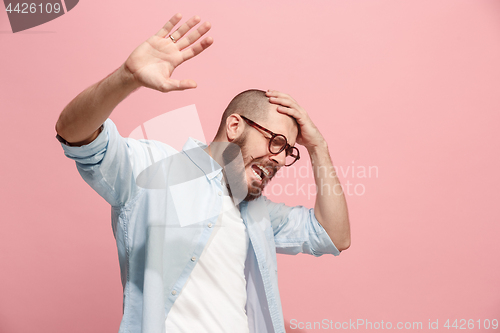 Image of Portrait of the scared man on pink