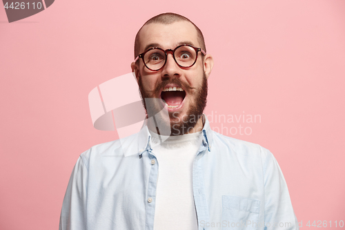 Image of Beautiful man looking suprised isolated on pink