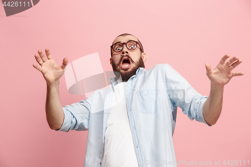 Image of Portrait of the scared man on pink