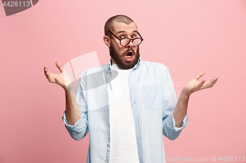 Image of Beautiful man looking suprised isolated on pink