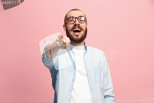 Image of The happy business man point you and want you, half length closeup portrait on pink background.